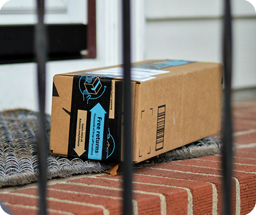 Photo of an Amazon package on a doorstep.